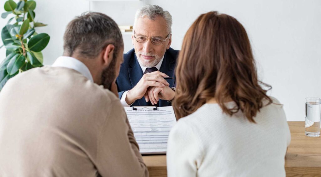 an attorney discussing Bankruptcy Practice information with a couple